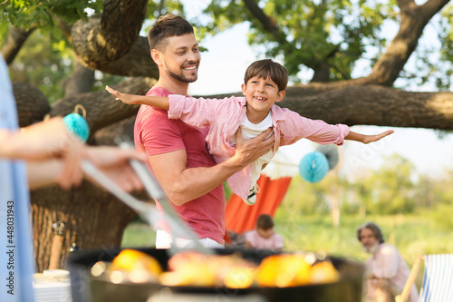 Happy family at barbecue pa...