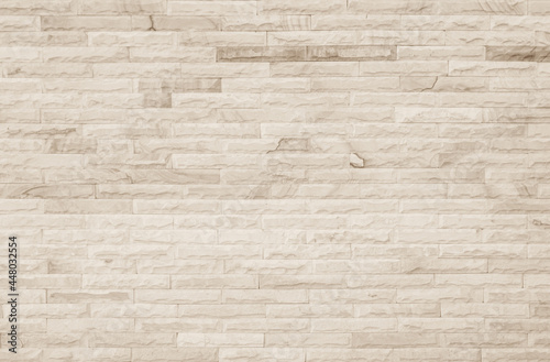 Empty background of wide cream brick wall texture. Beige old brown brick wall concrete or stone textured  limestone abstract decor design backdrop.