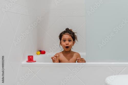 Little kid girl taking a shower