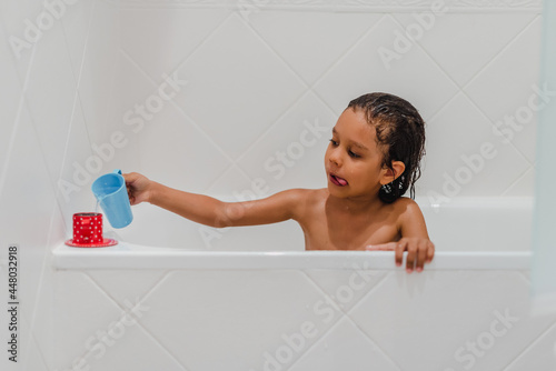 Little kid girl taking a shower