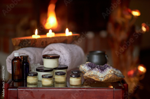 Fototapeta Naklejka Na Ścianę i Meble -  Naturally developed massage therapy and body care products in a rustic wooden environment; essential oils, body butter, candles and aromatic ingredients