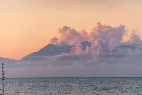 Albania coast surrounded by clouds during sunset seen from Corfu island in Greece