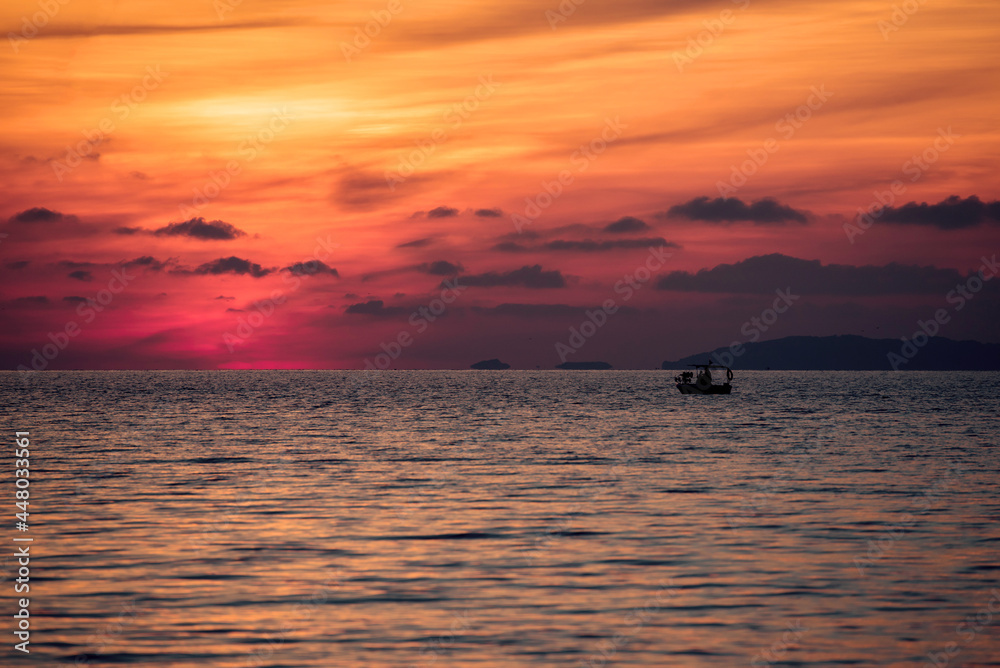 Fishing boat in the sea during sunset. Corfu island in Greece