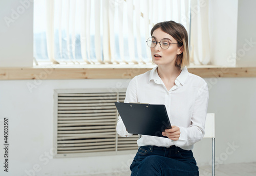 Business woman in white shirt documents office