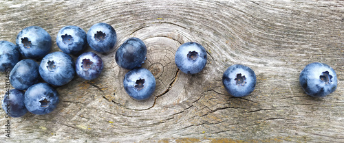 Fresh ripe blueberries on old wooden board. Berry background. Stock macro photo fresh blueberry under the sunshine, outdoors, wooden background