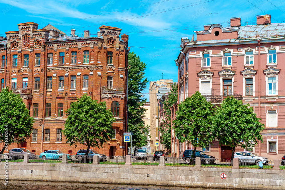 View of the facades of historical buildings on the street in the city center in summer. Saint Petersburg, Russia - 13 June 2021