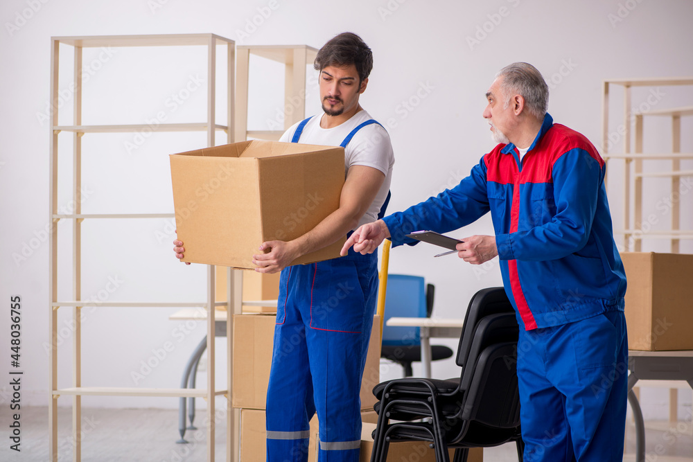 Two male professional movers doing home relocation Two male professional movers doing home relocation