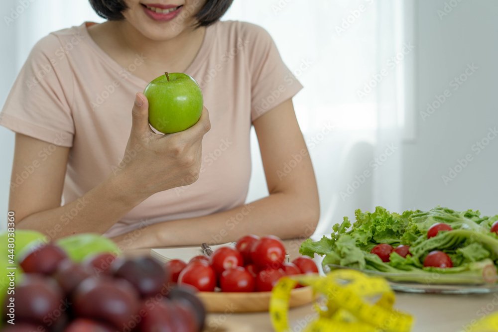 Healthy food and keto diet. Women plan dieting for slim shape and healthy. Woman eating apple and vegetables Healthy food and keto diet. Women plan dieting for slim shape and healthy. Woman eating apple and vegetables