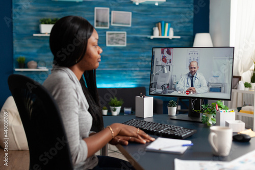 African american woman discussing sickness respiratory symptoms with virtual physician doctor during online videocall meeting appointment. Therapist explaining healthcare treatment