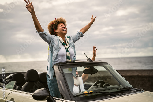 Happy senior couple having fun driving on new convertible car - Mature people enjoying time together during road trip tour vacation - Travel people lifestyle concept © Alessandro Biascioli