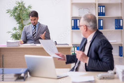 Two male employees working in the office