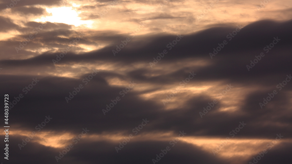 The Sun and Layers of Evening Clouds