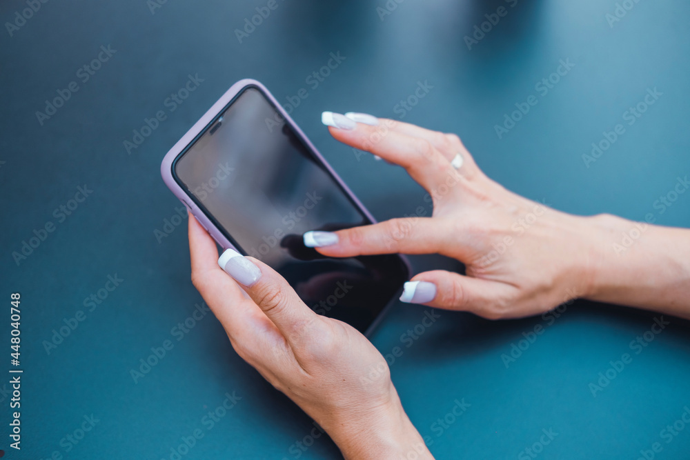 Young girl using smartphone in hand, drinking coffee Young girl using smartphone in hand, drinking coffee