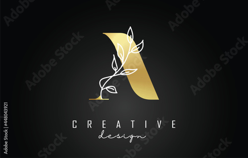 Golden A letter logo design with white leaves branch vector illustration. photo