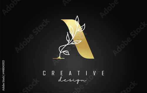 Golden A letter logo design with white leaves branch vector illustration.