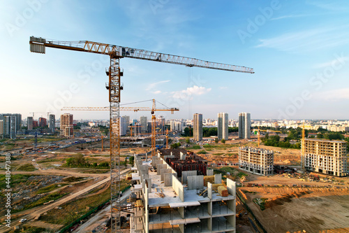 Crane during formworks on construction site. Pouring concrete into formwork. Construction the buildings and multi-storey residential homes. Tower cranes at construction and the built environment.