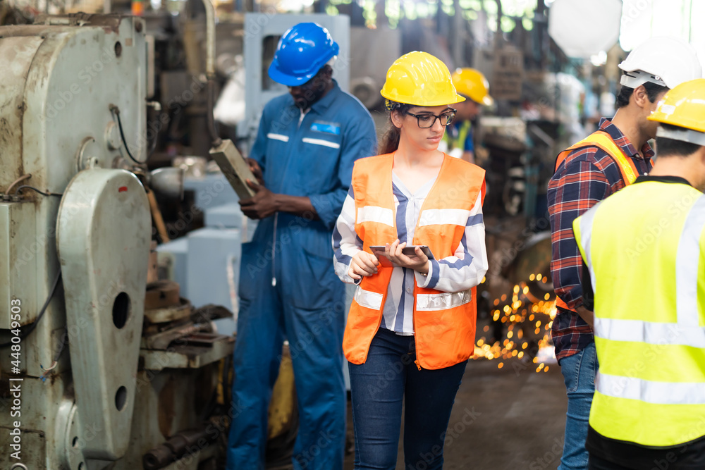 Quality control inspector checking workers at factory. Engineering Worker team working in Heavy Industry Manufacturing Facility. Quality control inspector checking workers at factory. Engineering Worker team working in Heavy Industry Manufacturing Facility.