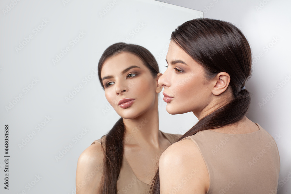 Portrait of beauty brunette model woman with mirror on white background Portrait of beauty brunette model woman with mirror on white background