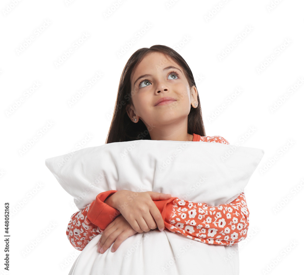 Cute girl wearing pajamas with pillow on white background