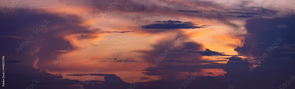 Painterly colorful cloudscape decor panorama with radiant vibrant colorful magenta, yellow and orange sunset colors. Weather conditions and climate concept. Abstract background wallpaper poster.