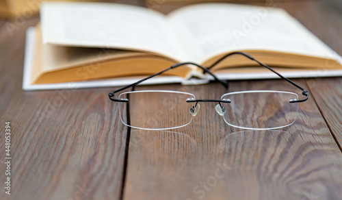 Transparent glasses, rimless glasses in a modern style on a wooden table.