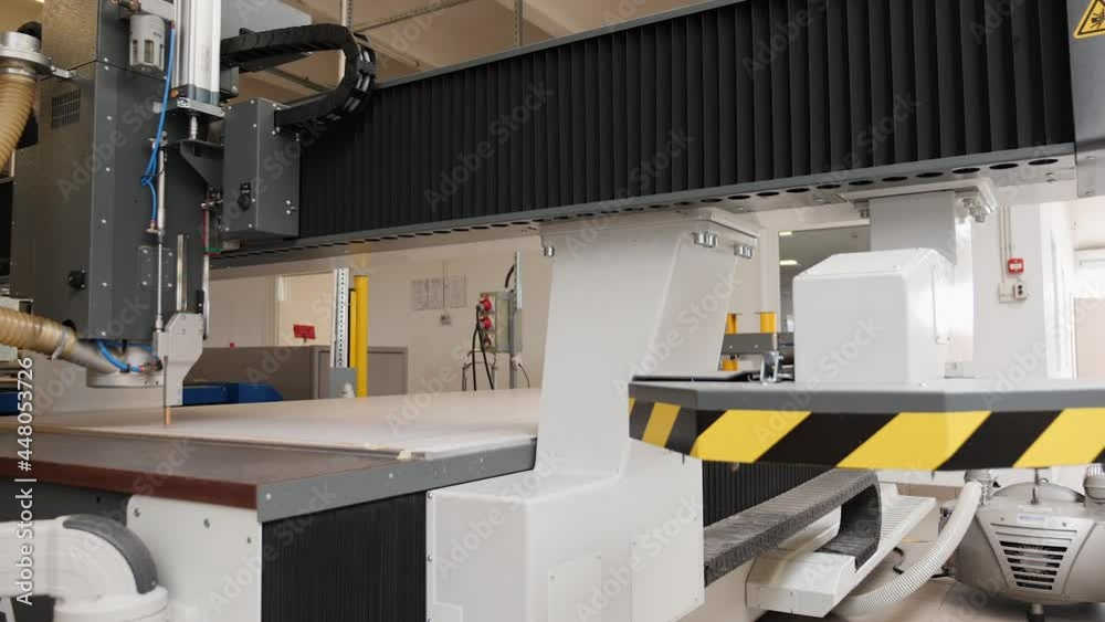 Industrial plotter working on large paper sheet - low angle, wide shot Industrial plotter working on large paper sheet - low angle, wide shot