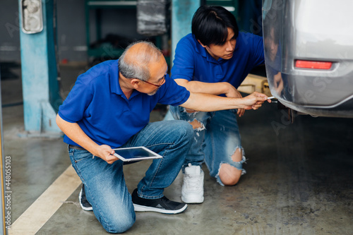 Wallpaper Mural Portrait of a Asian mechanic working in his car service garage. Car maintenance and auto service garage concept. Torontodigital.ca