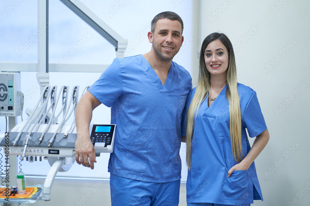 Fototapeta premium Portrait of team of male and female dentists in dental clinic