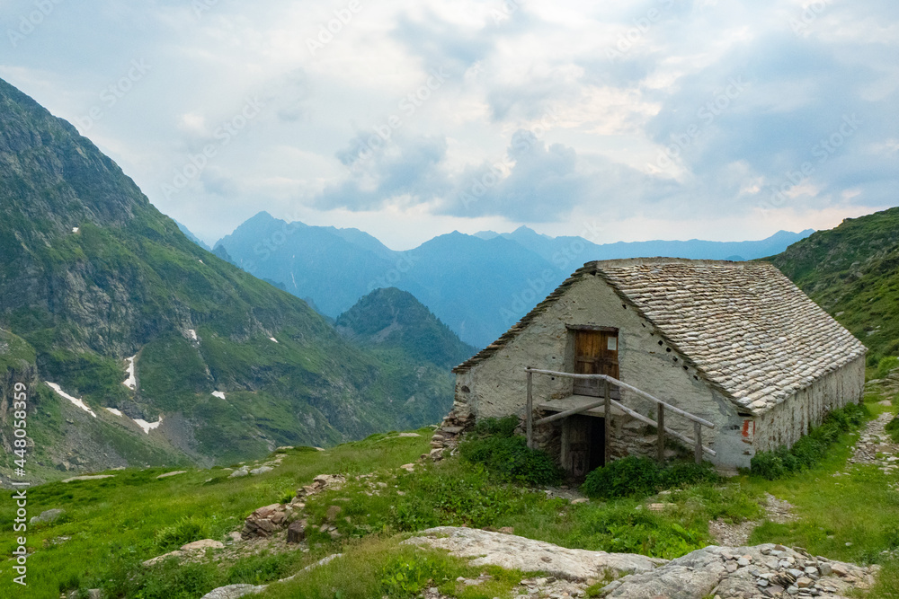 View from Alpe Scaredi in the Val Grande National Park over the barn into the inner valley and surrounding mountains