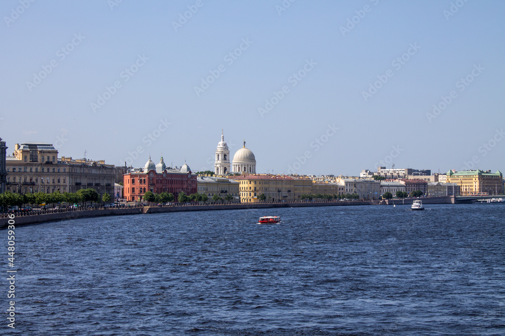 Saint PETERSBURG, RUSSIA-JULY, 18, 2021: panoramic view of the Neva River and the embankment with historical architecture against a clear blue sky on a sunny summer day and a space for copying