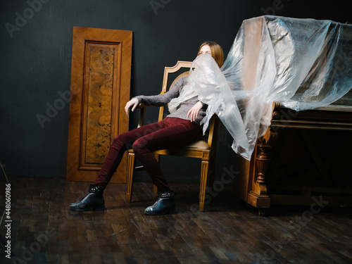 woman sitting near the piano on a chair interior romance musical instrument