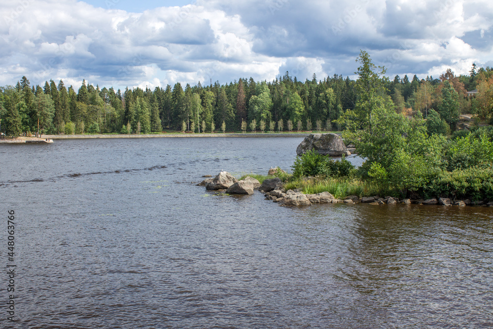 Beautiful landscape-Vyborg Bay with green trees and grass on the winding shores on a sunny summer day in the Monrepos Park in Russia Beautiful landscape-Vyborg Bay with green trees and grass on the winding shores on a sunny summer day in the Monrepos Park in Russia