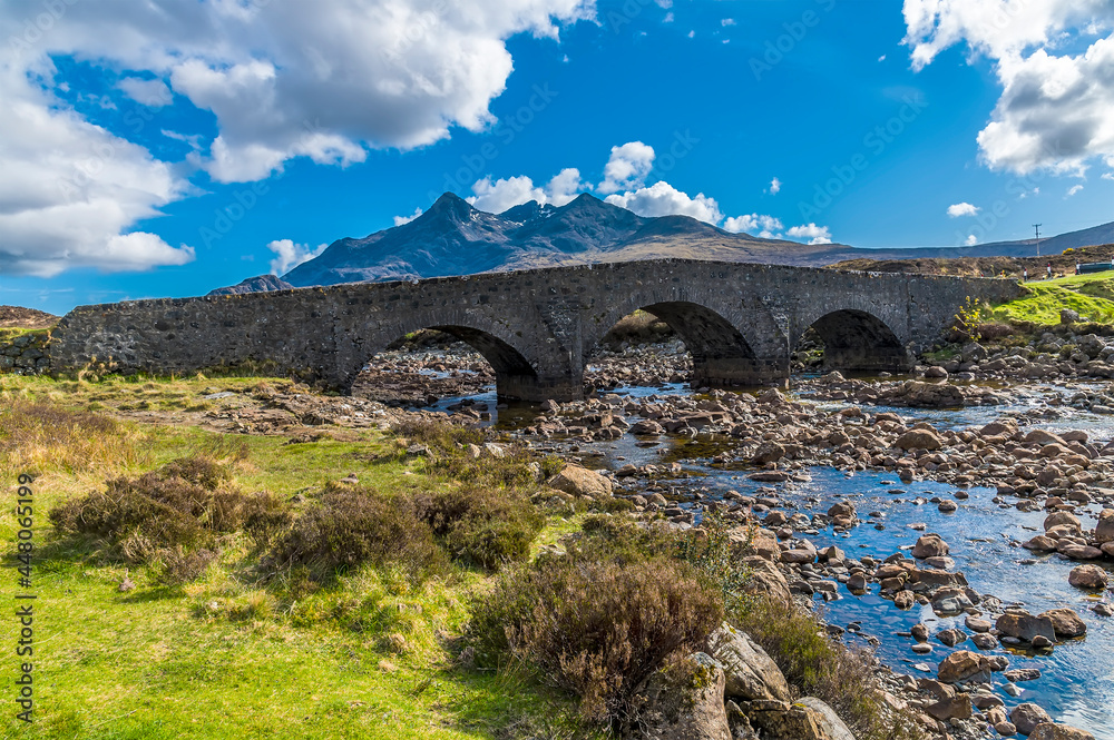 A view of the old bridge at Sligachan with a backdrop of the distant Cuillin Hills on the Isle of Skye, Scotland on a summers day