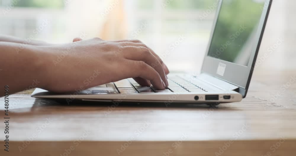 Close-up side view of a black lady typing on a laptop keyboard while working, composing messages on the internet, a student professional studying on a computer, businesswoman sends email to a customer Close-up side view of a black lady typing on a laptop keyboard while working, composing messages on the internet, a student professional studying on a computer, businesswoman sends email to a customer