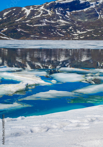 Frozen turquoise lake Vavatn panorama in summer landscape Hemsedal Norway. © arkadijschell