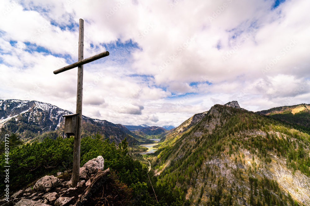 Mountain summit cross on the top of the alps