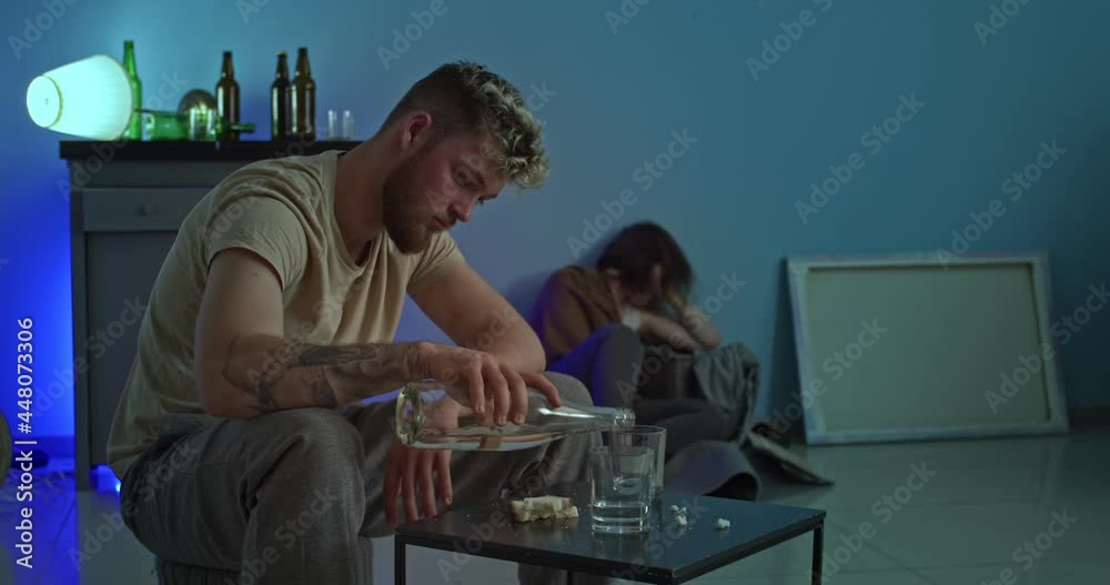 Young man drinking alcohol at home late in evening Young man drinking alcohol at home late in evening