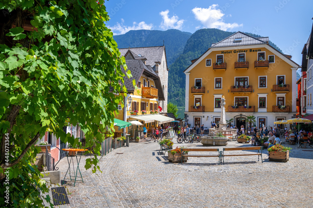 Fototapeta premium Hallstatt, Austria - July 31, 2021 - A scenic picture postcard view of the famous town square in the village of Hallstatt in the Austrian Alps.