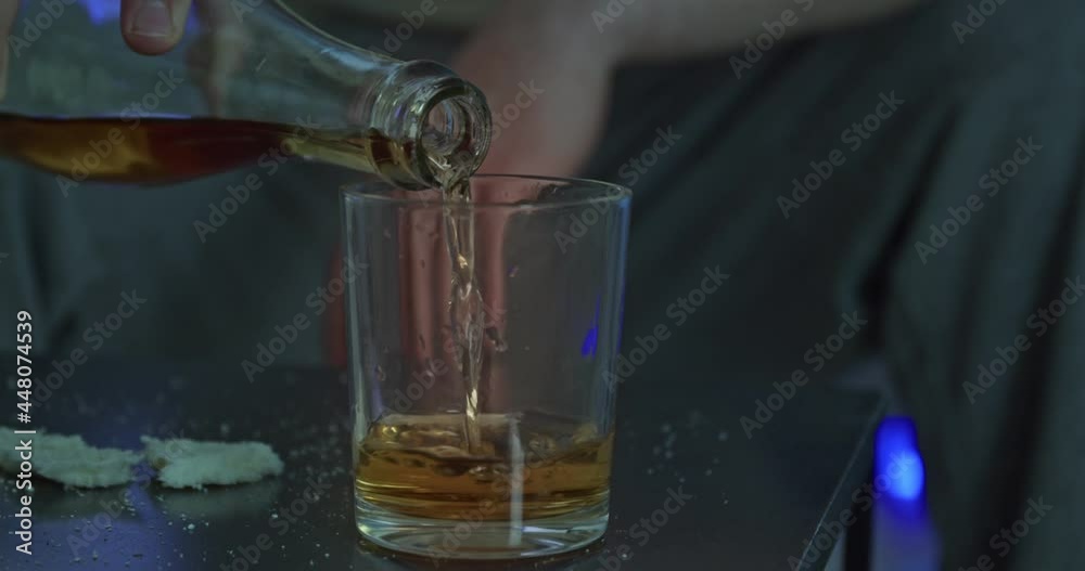 Young man drinking alcohol at home late in evening Young man drinking alcohol at home late in evening