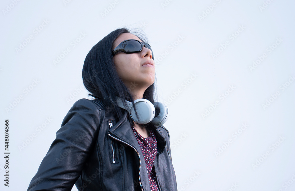woman posing with leather jacket and music headphones woman posing with leather jacket and music headphones