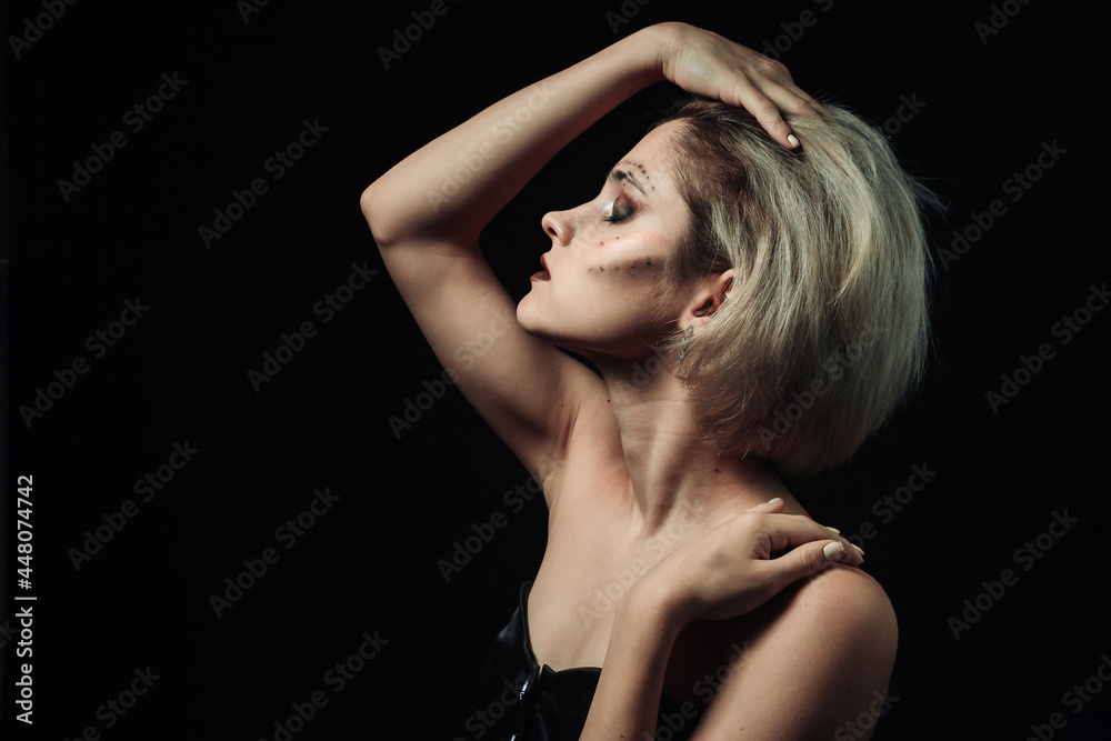 Female portrait in profile on a black background. Girl with makeup on a dark background Female portrait in profile on a black background. Girl with makeup on a dark background