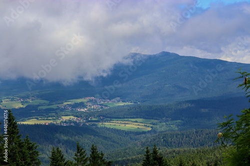 A view to the landscape covered by clouds from the peak of the mountain Grosser Arber, Germany