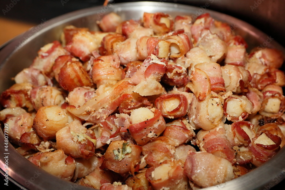 Bacon-wrapped chicken meat in bowl at party Bacon-wrapped chicken meat in bowl at party