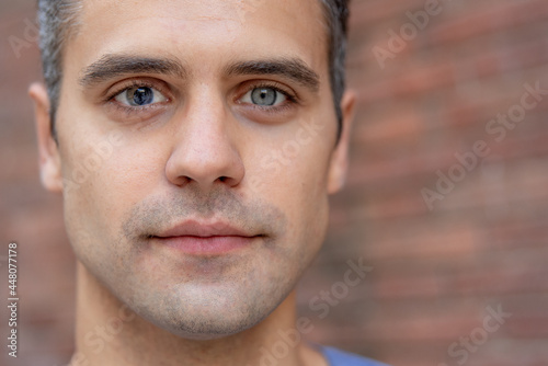 Close up portrait of latin man with heterochromia photo
