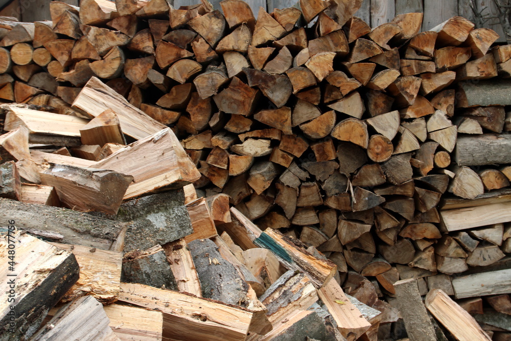 Wood pile reserve for the winter. Pile of chopped firewood. Background texture wood. Wood chips Wood pile reserve for the winter. Pile of chopped firewood. Background texture wood. Wood chips