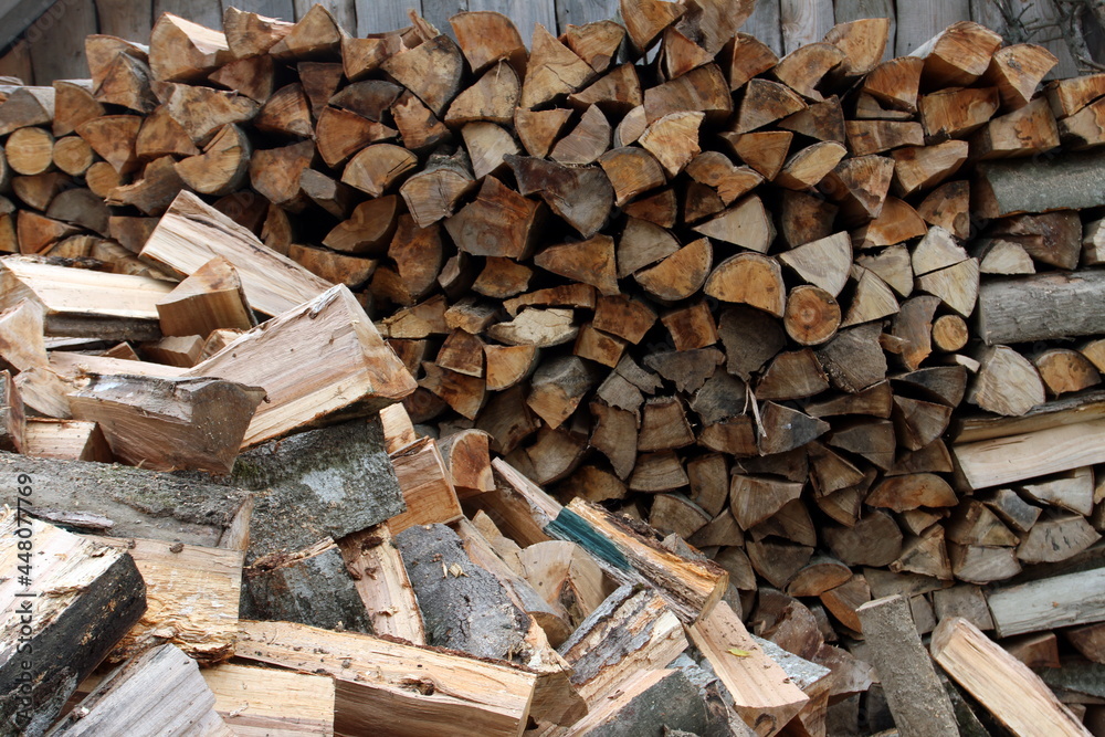 Wood pile reserve for the winter. Pile of chopped firewood. Background texture wood. Wood chips Wood pile reserve for the winter. Pile of chopped firewood. Background texture wood. Wood chips