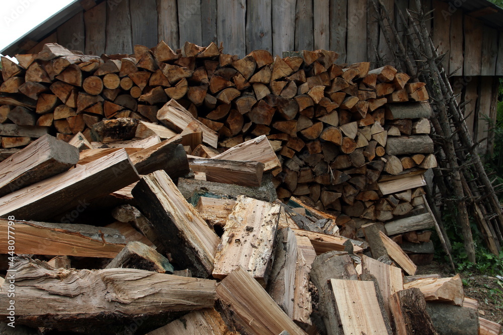 Wood pile reserve for the winter. Pile of chopped firewood. Background texture wood. Wood chips Wood pile reserve for the winter. Pile of chopped firewood. Background texture wood. Wood chips