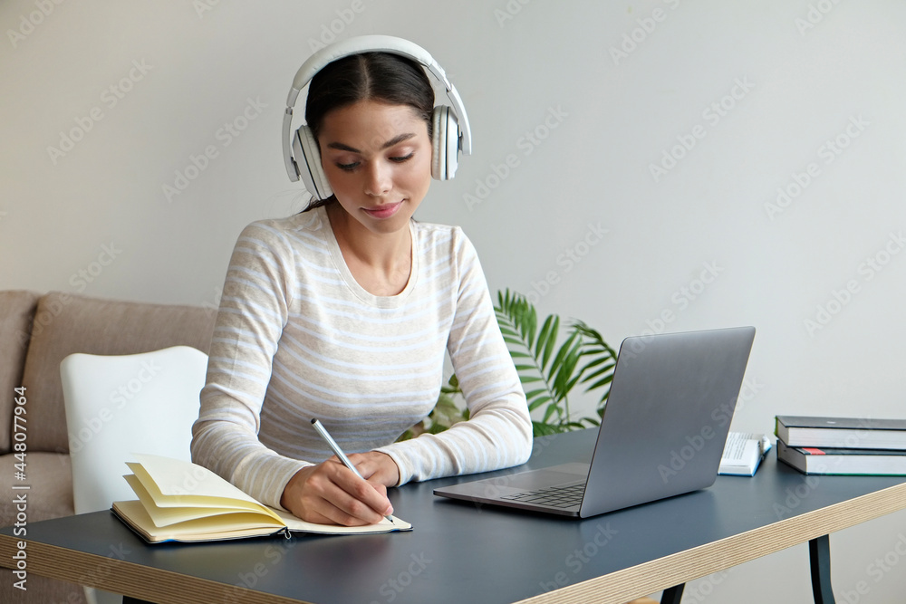 Online education concept. Young brunette woman wearing eyeglasses and headphones taking part in a group video call. Portrait of female college student studying at home. Close up, copy space background Online education concept. Young brunette woman wearing eyeglasses and headphones taking part in a group video call. Portrait of female college student studying at home. Close up, copy space background