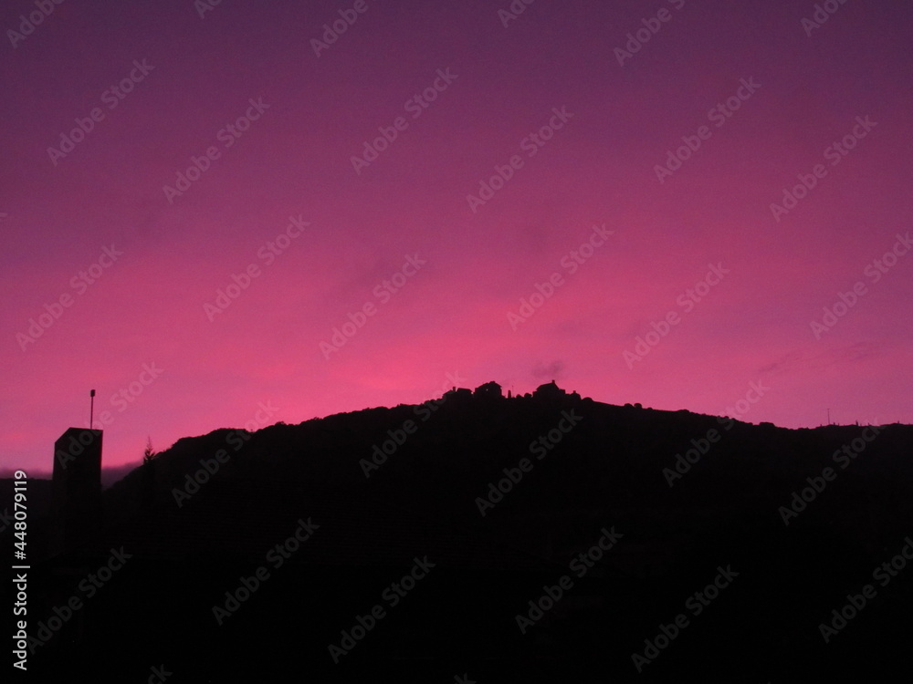 silhouette of a hill near a sunset