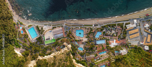 Overhead aerial view of Ischia Citara Beach at sunset with pools and sand.